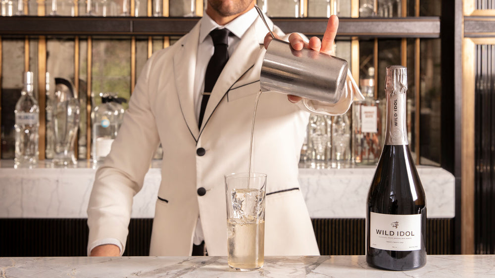 A Mixologist making a cocktail using Wld Idol Alcohol Free Sparkling White Wine