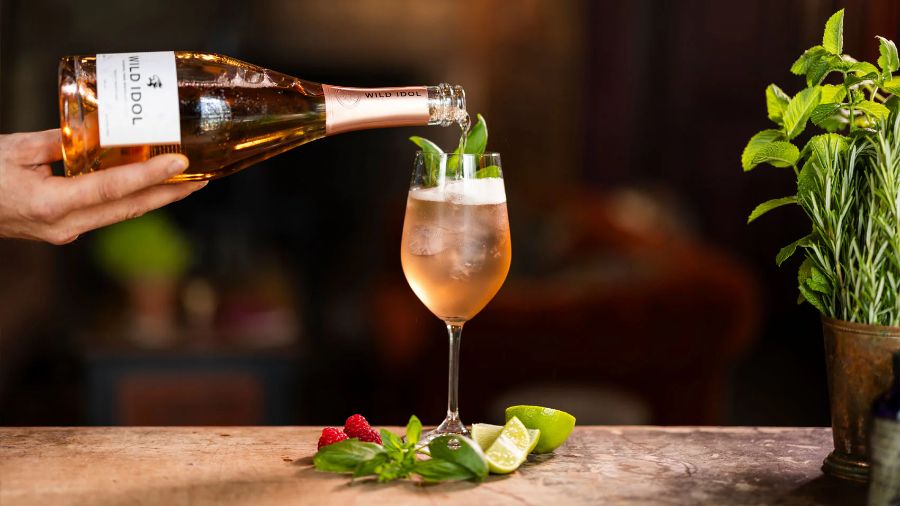 A glass of Summer Spritz being made with Wild Idol Alcohol Free Sparkling Rosé Wine