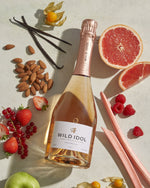 A bottle of Wild Idol Alcohol Free Sparkling Rosé Wine next to its box